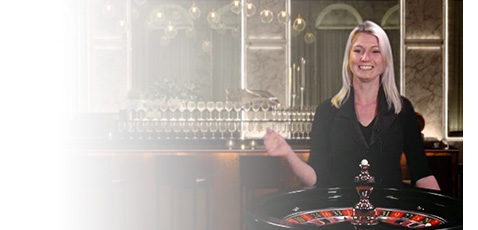 A Ninja Casino live dealer standing behind a roulette table